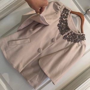 A beige jacket blouse pancho